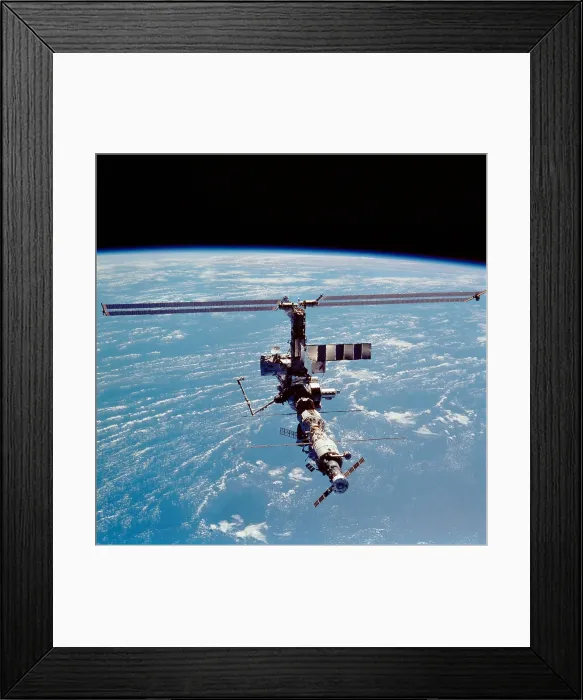 Framed Print : International Space Station in 2002. View of the expanding structure with added modules, solar panels, robotic cranes and a docked Soyuz space craft. April 17, 2002 Framed Print : International Space Station in 2002. View of the expanding structure with added modules, solar panels, robotic cranes and a docked Soyuz space craft. April 17, 2002