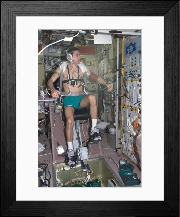 Framed Print : Working out in space. Cosmonaut Yuri Malenchenko exercising on the International Space Station