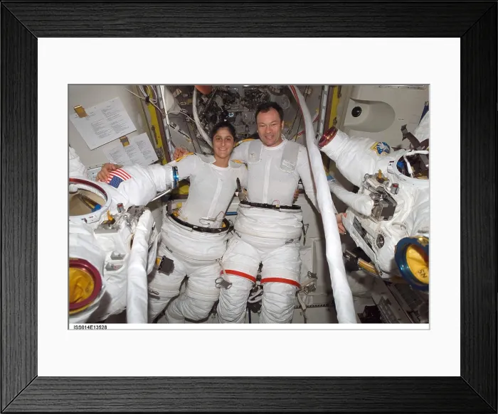 Framed Print : International Space Station activity. Astronauts Sunita Williams and Michael Lopez-Alegria, suit up before their spacewalk. July 18, 2008