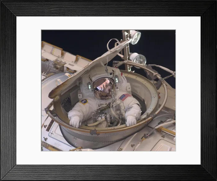 Framed Print : International Space Station in 2011. Astronaut Andrew Feustel reenters the space station after completing an 8-hour spacewalk on May 22, 2011