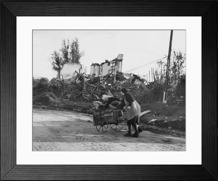 Framed Print : Two German women pushing their belongs in a cart past demolished buildings, Aachen, Germany