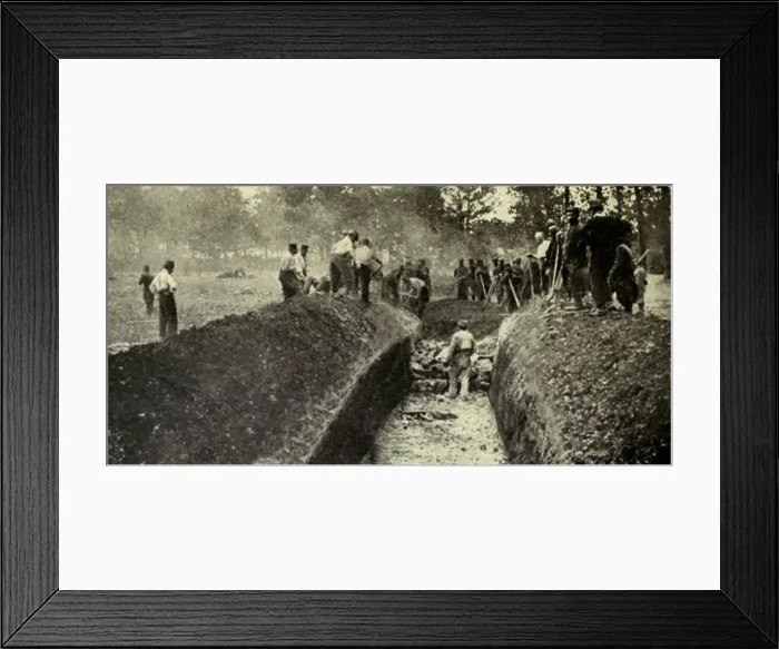 Framed Print : World War 1. After a battle in Northern France, three hundred Germans were buried in one great trench and a similar number of French in another. 1914