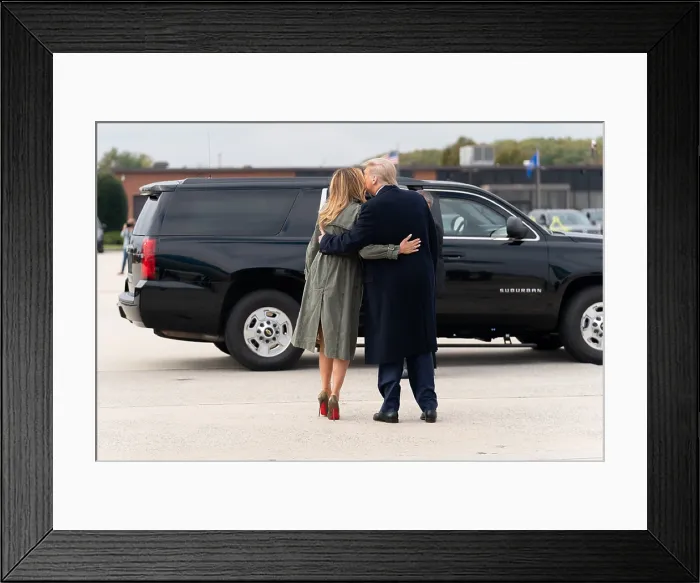 Framed Print : President Donald Trump and First Lady Melania Trump embrace as he escorts her to a vehicle at Joint Base Andrews, Oct. 27, 2020