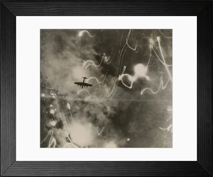 Framed Print : British RAF bomber and trails of light from incendiary bombs. Photo taken of the bombing of the shipbuilding yards in Hamburg during World War 2. Jan. 12, 1943. (BSLOC_2014_6_10)