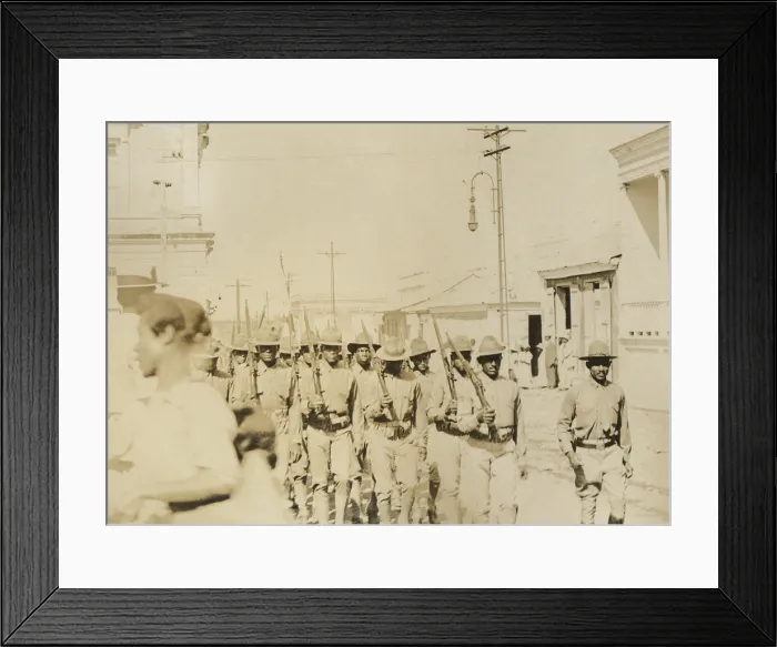 Framed Print : African American soldiers marching down street carrying Springfield rifles, c. 1903. The location of the parade is unknown Framed Print : African American soldiers marching down street carrying Springfield rifles, c. 1903. The location of the parade is unknown