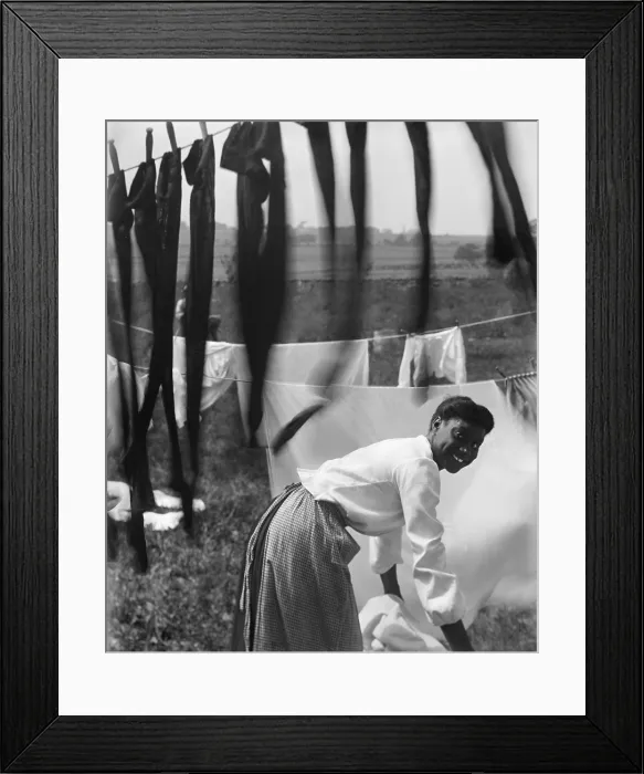 Framed Print : Informal portrait of a young African American woman surrounded by laundry in Newport, R.I Framed Print : Informal portrait of a young African American woman surrounded by laundry in Newport, R.I