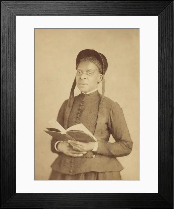 Framed Print : Portrait of an African American woman, wearing glasses, and posed with book, c. 1880-1900