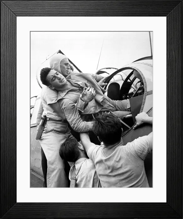 Framed Print : Crewmen lift a wounded pilot out of his Grumman TBF Avenger. He returned to the aircraft carrier USS SARATOGA after a raid on Japanese base at Rabaul, New Britain. Nov. 1944