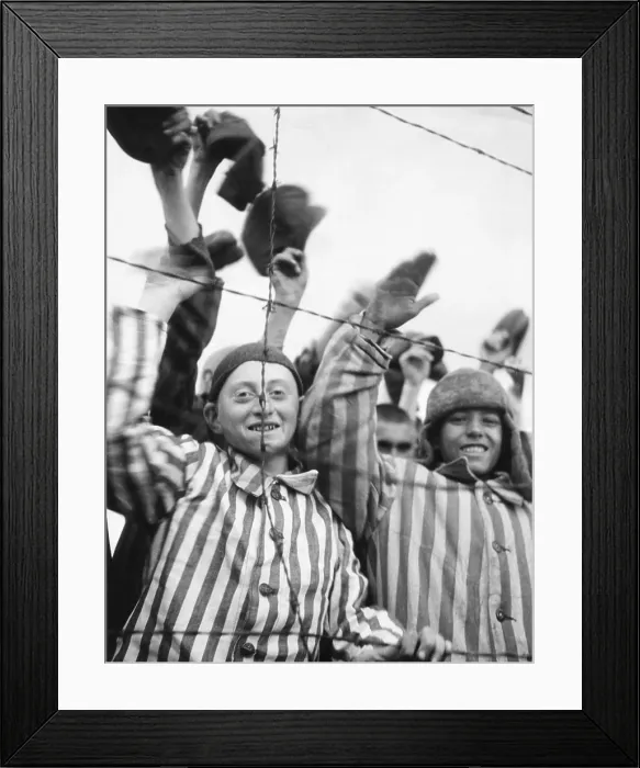 Framed Print : Dachau Prisoners wave and cheer the Seventh US Army liberators from behind a barbed wire fence. April 29, 1945, World War 2 (BSLOC_2015_13_20)