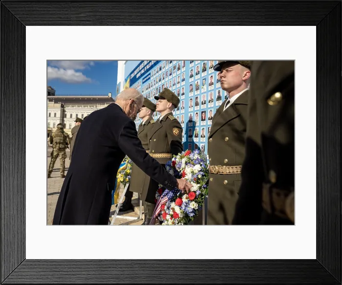Framed Print : President Joe Biden touches a floral wreath with a US flag, at the Wall of the Fallen at St. Michael's Monastery in Kyiv, Ukraine, Feb. 20, 2023 (BSLOC_2023_6_9)