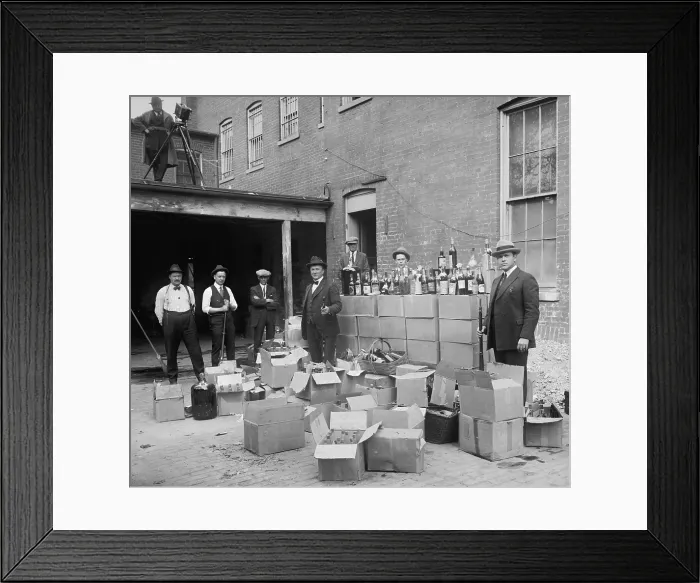 Framed Print : Prohibition agents stand with boxes and bottles of wine and liquor after a raid in Wash. D.C. area. Oct. 14, 1922. Note the camera man in upper left (BSLOC_2016_8_69)