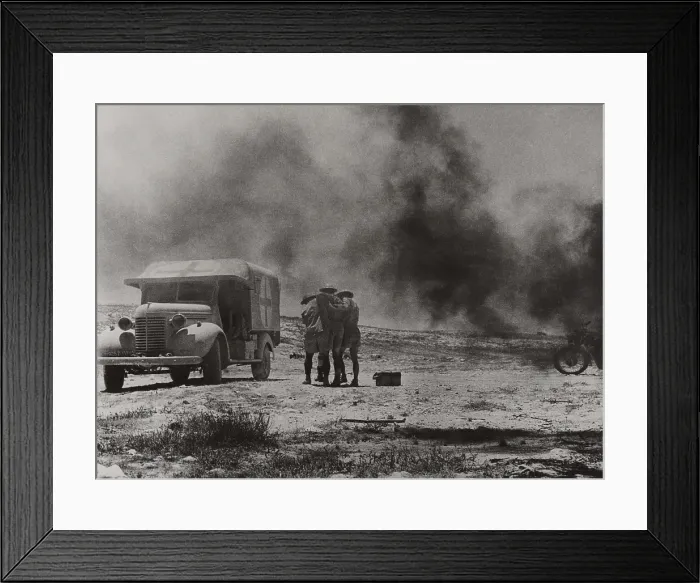 Framed Print : Royal Army Medical Corps ambulance convoy under attack in the Western Desert, Egypt. Two soldiers assist a wounded driver who escaped his blazing vehicle. Ca. 1940-42 Framed Print : Royal Army Medical Corps ambulance convoy under attack in the Western Desert, Egypt. Two soldiers assist a wounded driver who escaped his blazing vehicle. Ca. 1940-42