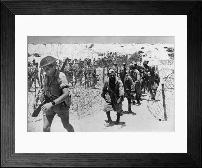 Framed Print : Italian and German prisoners of war captured in the El Alamein, Egypt. The are entering the cage preceded by their guard. Ca. 1942. (BSLOC_2013-12_74) Framed Print : Italian and German prisoners of war captured in the El Alamein, Egypt. The are entering the cage preceded by their guard. Ca. 1942. (BSLOC_2013-12_74)