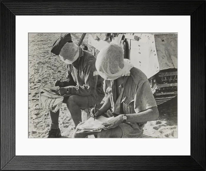 Framed Print : British soldiers with their heads covered by mosquito nets keep flies away. They are at El Alamein, and writing letters while sitting beside their tanks. Ca. 1940-42 Framed Print : British soldiers with their heads covered by mosquito nets keep flies away. They are at El Alamein, and writing letters while sitting beside their tanks. Ca. 1940-42