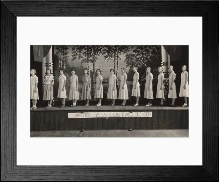 Framed Print : Young women on stage modeling dresses at a 4-H Club event, 1925-1930. They are modeling dresses the made for the cost of 35-60 cents ($4.85 to $8.30 in 2016) (BSLOC_2016_8_107) Framed Print : Young women on stage modeling dresses at a 4-H Club event, 1925-1930. They are modeling dresses the made for the cost of 35-60 cents ($4.85 to $8.30 in 2016) (BSLOC_2016_8_107)