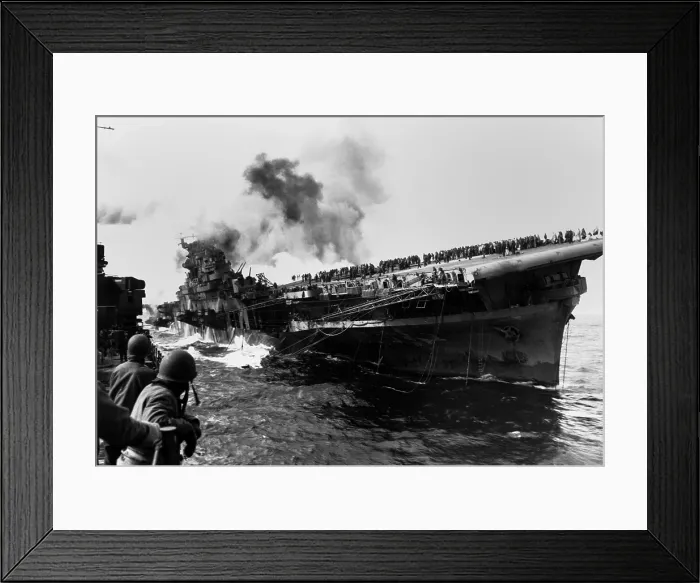 Framed Print : USS Franklin aircraft carrier on fire and listing after a strike by a Japanese dive bomber. USS Santa Fe (at left) assists the crippled carrier, that suffered 800 crewmen killed