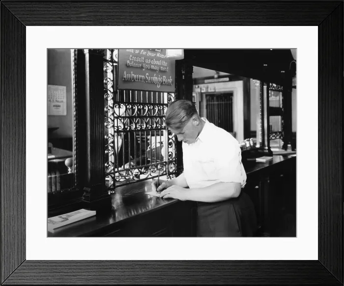 Framed Print : Customer endorsing a check at Auburn, Maine savings bank in 1929 (BSLOC_2016_8_23)
