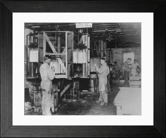 Framed Print : Workman hand dipping candles at the St. Louis Candle and Wax Company, 1927. Candle making was a declining industry as Americans gained access to electric lights (BSLOC_2016_8_52)