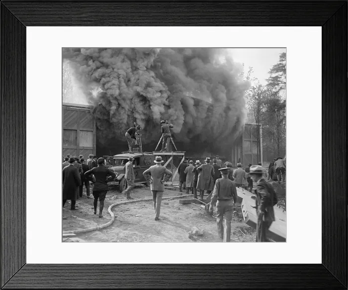 Framed Print : Hearst Movietone cameramen film a fire in Washington, D.C. in c. 1920. One man stands on the roof of his truck as dense smokes pours from a building (BSLOC_2016_8_156) Framed Print : Hearst Movietone cameramen film a fire in Washington, D.C. in c. 1920. One man stands on the roof of his truck as dense smokes pours from a building (BSLOC_2016_8_156)