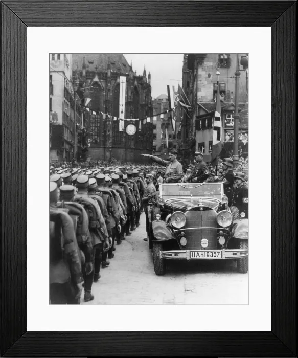 Framed Print : Hitler giving Nazi salute to Storm Troopers passing by open his car, Nuremberg, 1933. With Hitler is Ernst Rohm, long time Nazi leader of the S.A