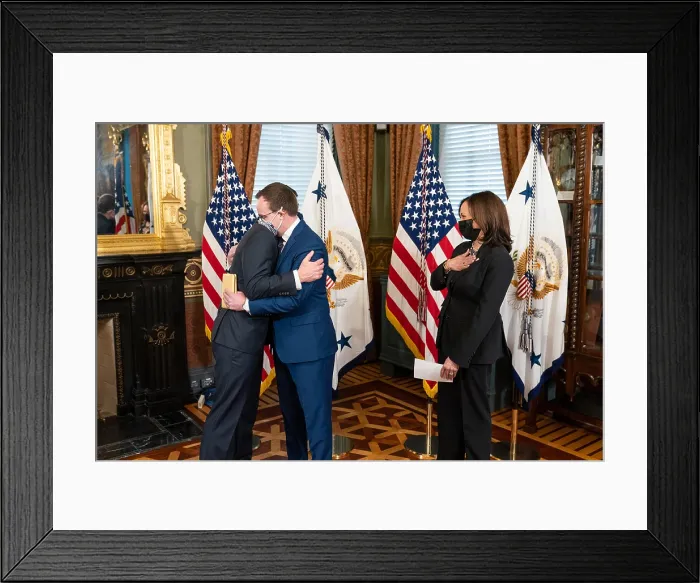 Framed Print : Pete Buttigieg embraces his husband, Chasten Buttigieg, after being sworn in as Secretary of Transportation, Feb. 3, 2021