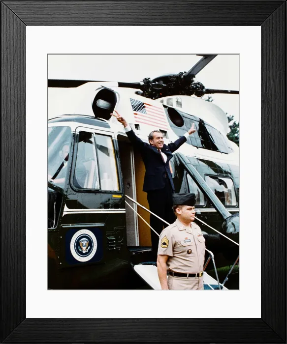 Framed Print : President Richard Nixon makes his two-armed victory gesture from Army One, the helicopter taking him from the White House on August 9, 1974, after his forced resignation