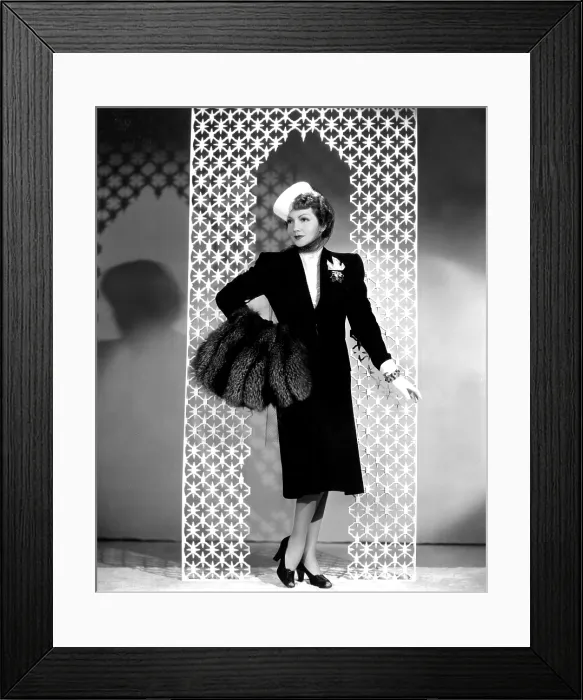 Framed Print : MIDNIGHT, Claudette Colbert, in a black wool suit by Irene, with a crystal-beaded blouse and silver fox muff, 1939