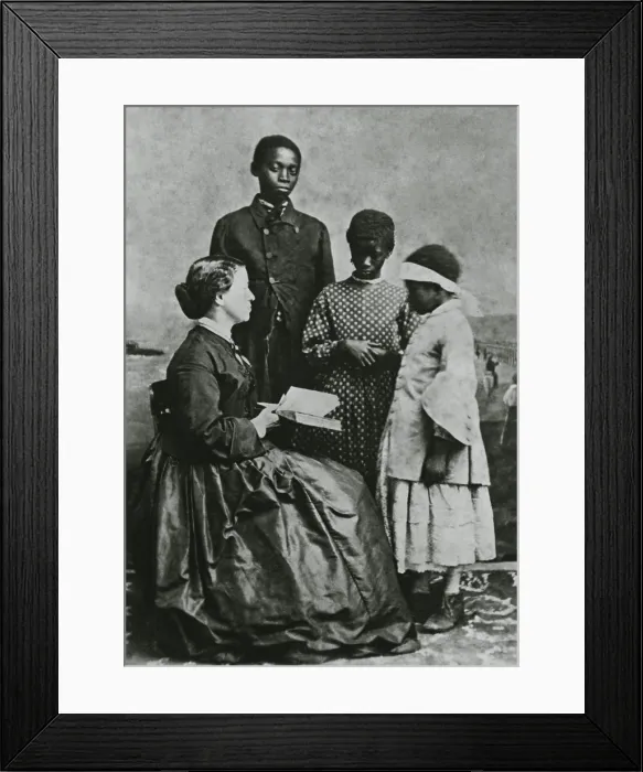 Framed Print : Teacher Laura M. Towne, a founder of the Penn School, with students Dick, Maria, and Amoretta