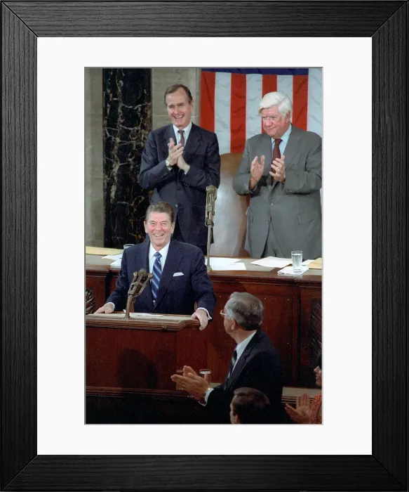 Framed Print : President Ronald Reagan addresses Congress on April 28, 1981, a few weeks after surviving an assassination attempt. Behind the President is VP George H.W Framed Print : President Ronald Reagan addresses Congress on April 28, 1981, a few weeks after surviving an assassination attempt. Behind the President is VP George H.W
