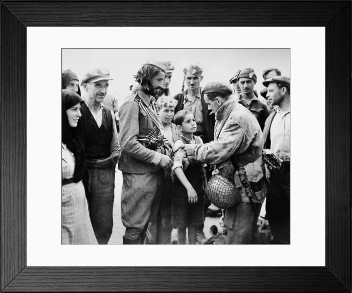 Framed Print : British liberator of Greece, pinning a British band on the arm of a young boy. Oct. 24, 1944