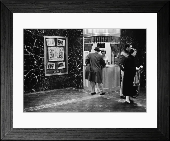 Framed Print : Man purchasing a movie ticket for the film. The coming attraction is the film, ALL MINE TO GIVE. Feb. 9, 1958. - (BSLOC_2015_1_162)