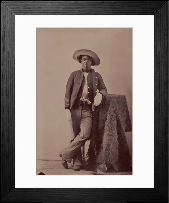 Framed Print : An unidentified Buffalo Soldier posing with a buffalo hide studio prop, c. 1860-1879 (BSLOC_2019_9_100) Framed Print : An unidentified Buffalo Soldier posing with a buffalo hide studio prop, c. 1860-1879 (BSLOC_2019_9_100)