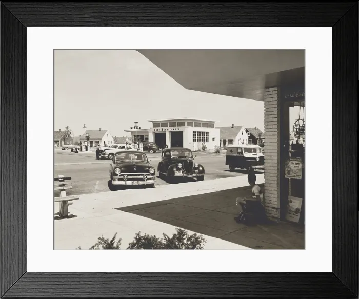 Framed Print : Levittown, N.Y. corner store across the street from a gas station. It was the first mass-produced suburb and had common public amenities such as community centers and stores. Aug