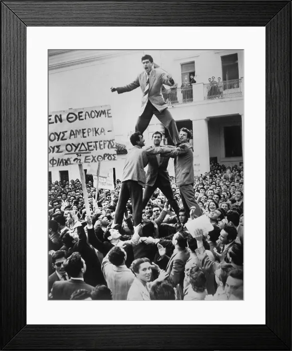 Framed Print : Greek students protest against British occupation of Cyprus. 4, 000 students assembled in Athens watch young men form a pyramid high above the crowd