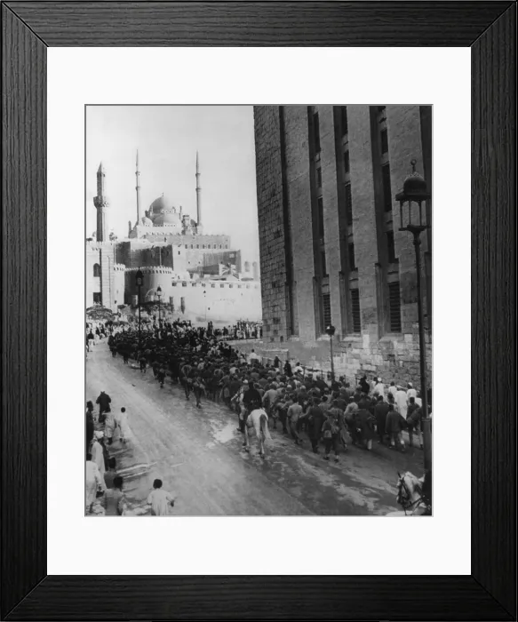 Framed Print : Axis prisoners captured in Libya nearing the Citadel of Cairo. Italian and German POWs march within view of the Mohamed Ali Mosque above and the Mosque of Sultan Hassan. Ca Framed Print : Axis prisoners captured in Libya nearing the Citadel of Cairo. Italian and German POWs march within view of the Mohamed Ali Mosque above and the Mosque of Sultan Hassan. Ca