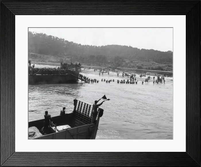 Framed Print : Invasion beach in southern France on D-Day, Aug. 15, 1944. Allied assault troops from landing craft advance through a breach in a defense wall blasted by assault engineers