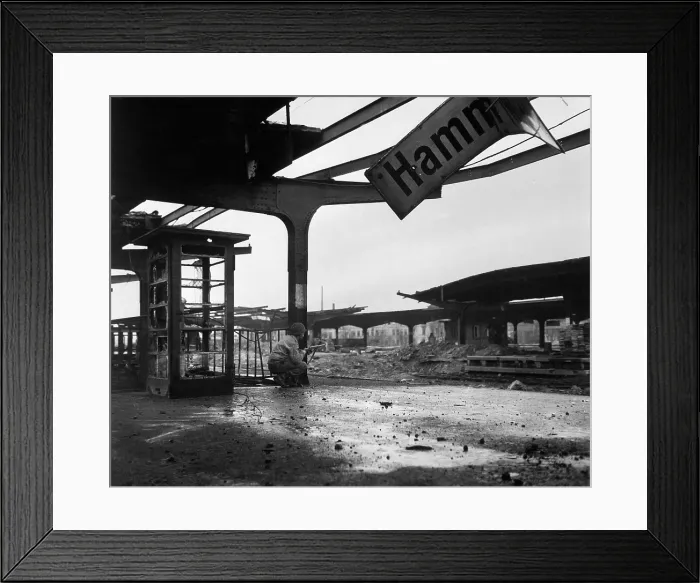 Framed Print : U.S. soldier crouches at the railroad station in the newly captured town of Hamm, Germany. April 6, 1945. World War 2. (BSLOC_2014_8_74)