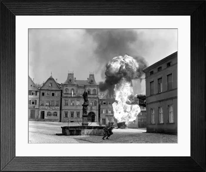Framed Print : Two soldiers dash past a blazing German gasoline trailer in town square of Kronach, Germany. U.S. 101st Infantry, April 14, 1945. World War 2. (BSLOC_2014_8_75) Framed Print : Two soldiers dash past a blazing German gasoline trailer in town square of Kronach, Germany. U.S. 101st Infantry, April 14, 1945. World War 2. (BSLOC_2014_8_75)