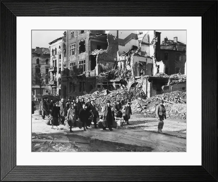 Framed Print : German civilians carry belongings as they follow an American soldier out of Aachen, Germany. The city fell to U.S. forces on October 21, 1944. World War 2. (BSLOC_2014_8_88) Framed Print : German civilians carry belongings as they follow an American soldier out of Aachen, Germany. The city fell to U.S. forces on October 21, 1944. World War 2. (BSLOC_2014_8_88)