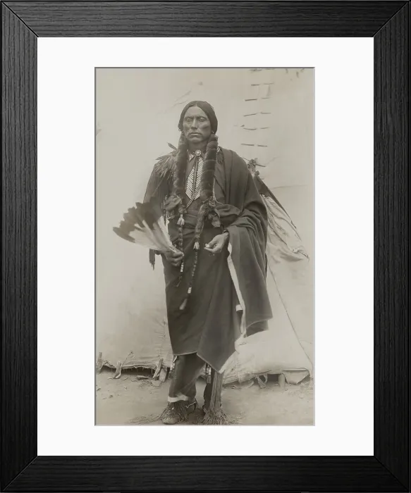 Framed Print : Quanah Parker, Principle Chief of Comanche Indians, ca. 1885, stands in front of a teepee, holding eagle feathers used in prayer
