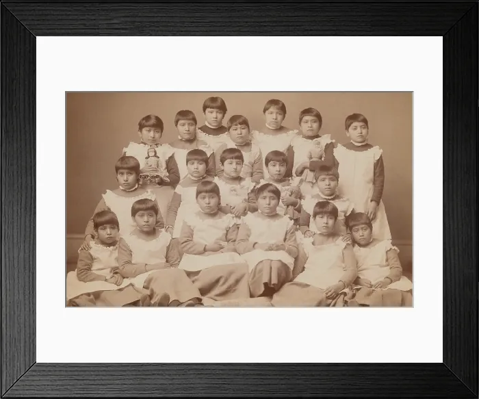 Framed Print : Young Native American girls, approximately ages 6-12, pose for a group portrait at the United States Indian School, Carlisle, Pennsylvania, ca. 1880-1900