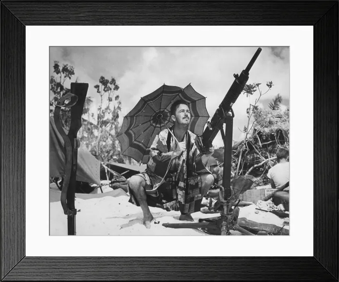 Framed Print : U.S. Coast Guard invader of Saipan is out of uniform. Wearing a silk kimono under the shade of a pastel parasol, he takes aim on a parakeet with a captured Jap gun. Ca. June 1944 Framed Print : U.S. Coast Guard invader of Saipan is out of uniform. Wearing a silk kimono under the shade of a pastel parasol, he takes aim on a parakeet with a captured Jap gun. Ca. June 1944