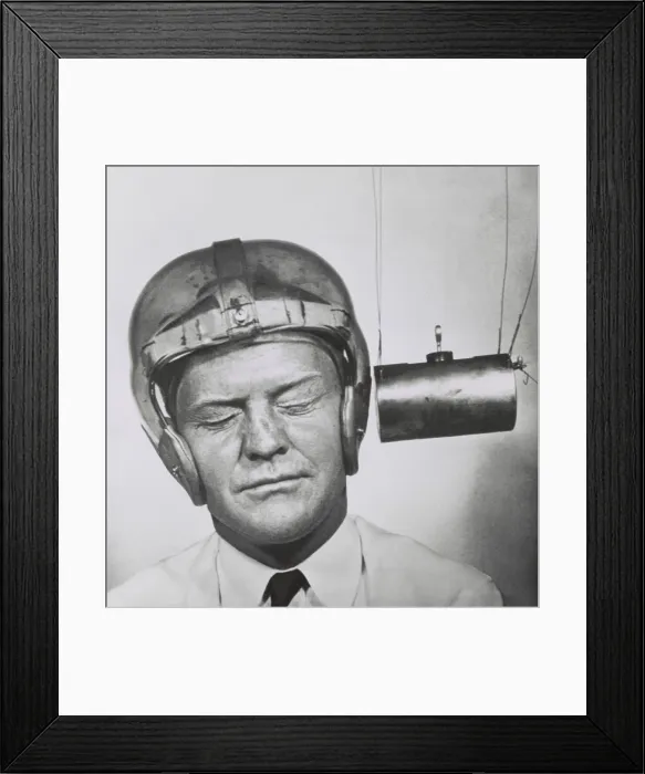 Framed Print : Pendulum pounding a plastic helmet worn for testing to improve headgear for football players. Sept.13, 1950 - (BSLOC_2015_1_219)