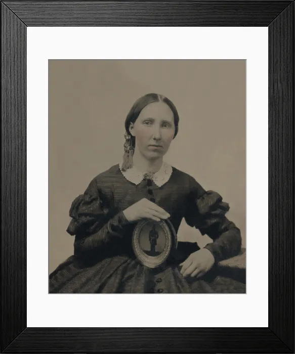 Framed Print : Young woman wearing mourning brooch and holding a framed image of unidentified soldier. Photo taken during the US Civil War, between 1861-1865 (BSLOC_2019_2_73)