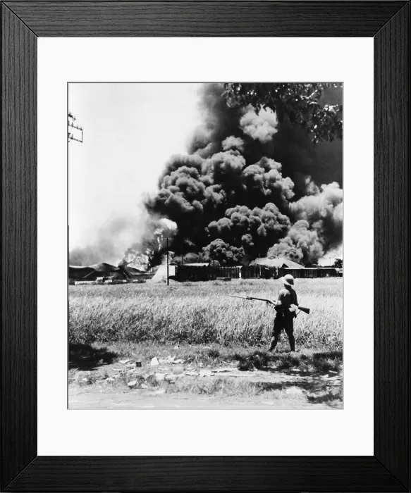 Framed Print : Burning oil tanks and cars left by retreating Dutch in Tandjong, Java. Ca. Feb.-Mar. 1942. World War 2. (BSLOC_2014_10_137)