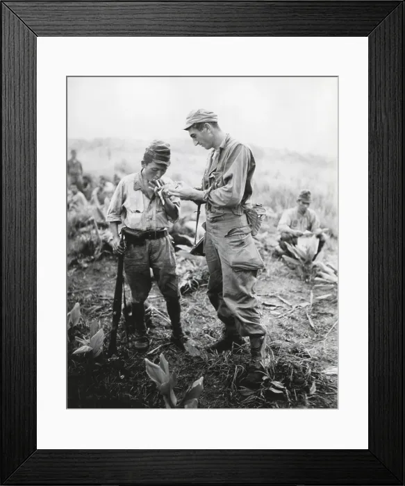 Framed Print : U.S. soldier of lights a cigarette for a former enemy guard Framed Print : U.S. soldier of lights a cigarette for a former enemy guard