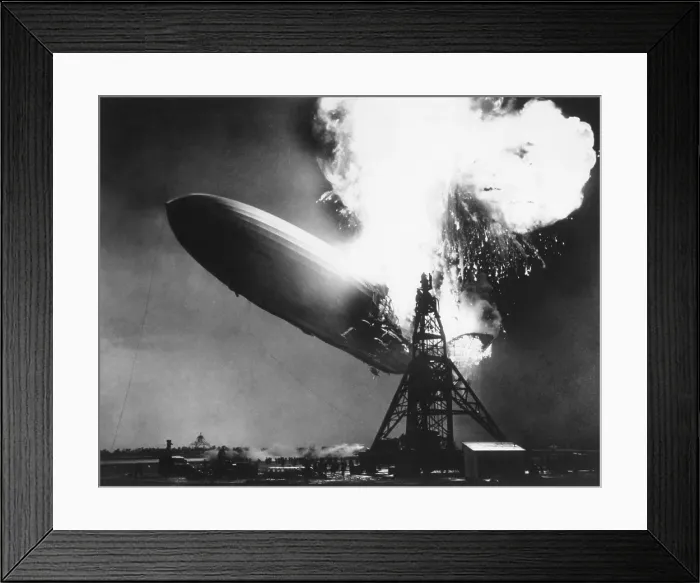 Framed Print : The German passenger airship Hindenburg seconds after catching fire, May 6, 1937. At 200 feet above the ground, flames erupt on top and in the back of the ship