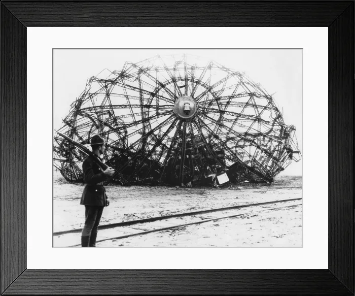 Framed Print : Hindenburg wreckage guarded by a soldier at the Naval Air Station in Lakehurst, NJ. May 1937. The German passenger airship's twisted metal skeleton remains Framed Print : Hindenburg wreckage guarded by a soldier at the Naval Air Station in Lakehurst, NJ. May 1937. The German passenger airship's twisted metal skeleton remains