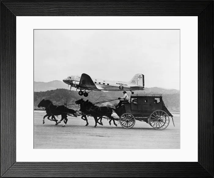 Framed Print : American Airlines DC-3 flying past horse drawn stagecoach. The photo was featured in an American Airlines magazine advertisement in 1949. (BSLOC_2015_14_193)
