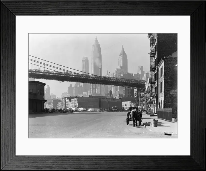 Framed Print : New Your City's South Street, Nov. 28, 1933. The Brooklyn Bridge spans over the street, with the skyscrapers of the Financial District in the distance. Photo by Samuel H